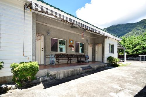 a front porch of a house with a patio at Xi Cun Homestay in Donghe