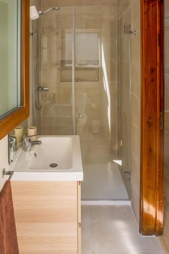 a bathroom with a sink and a shower at Casa da Quintinha - Villa with a pool in Sesimbra