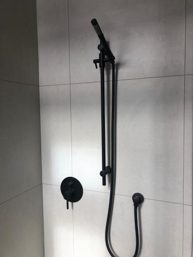 a shower with a blow dryer in a bathroom at Chevron Hotel in Prague