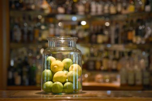 a glass jar filled with green apples sitting on a counter at Hotel Landhaus Wachtelhof in Rotenburg an der Wümme