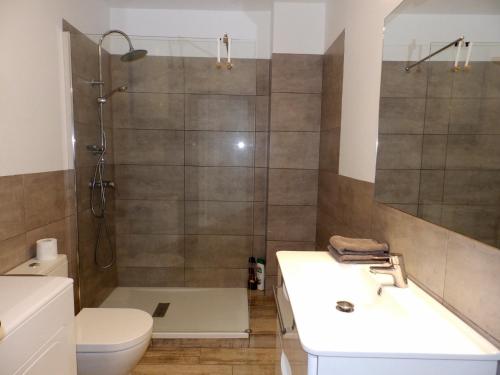 a bathroom with a shower and a sink and a toilet at Apartamentos Medano - Estrella del Mar in El Médano