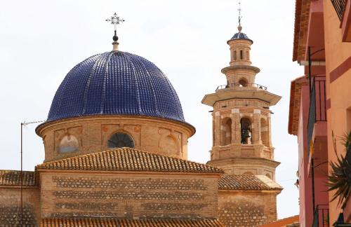 a church with a blue dome and a tower at Villa Foia Vella - adults only in Benichembla