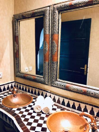 a bathroom with two sinks and a mirror at Villa Dar Jbila Tanger in Tangier