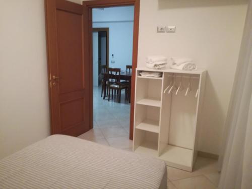a bedroom with a bed and a room with a table at Terra e Mare in Sorrento