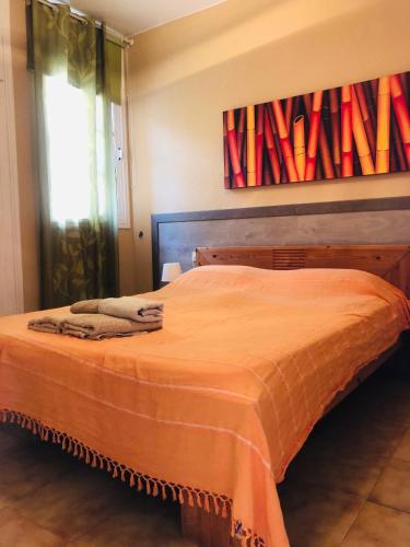 a bedroom with a bed with an orange blanket on it at Las Vistas Beach in Playa de las Americas