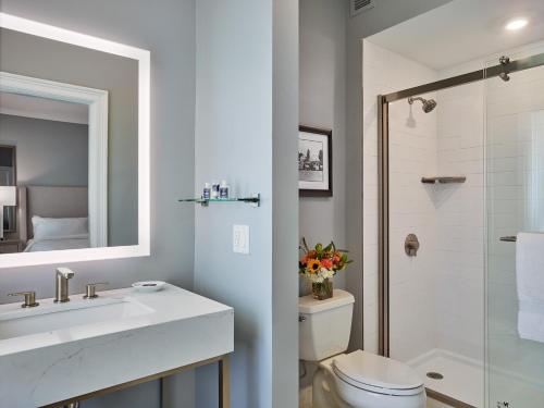 a bathroom with a sink and a toilet and a shower at Seaview, A Dolce Hotel in Galloway