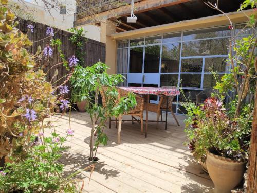 a patio with a table and some plants at Krivine B&B in Midreshet Ben Gurion