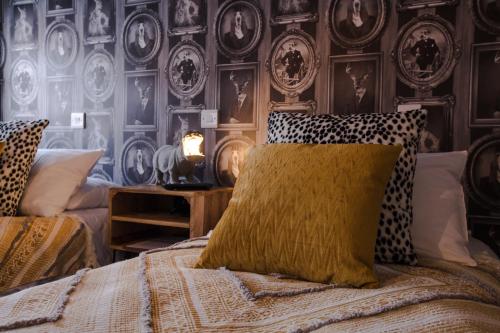 a bedroom with a bed and a wall of plates at The Wheatsheaf Pub, Kitchen & Rooms in Bingham