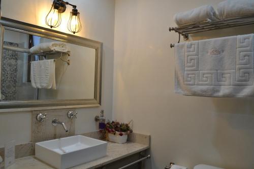 a bathroom with a sink and a mirror at Hotel Boutique Casa Abuela Maria in Oaxaca City