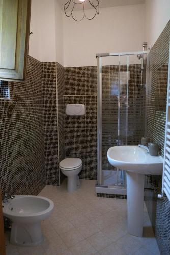 a bathroom with a toilet and a sink and a shower at Masseria boutique b&b in Montella