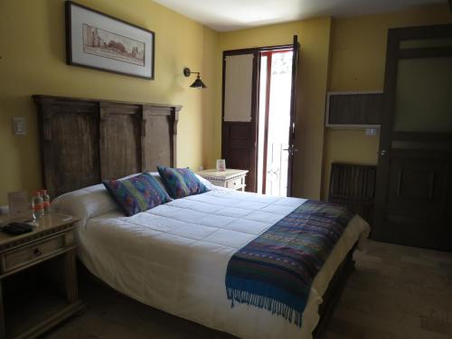 a bedroom with a large bed and a window at Hotel Boutique Casa Abuela Maria in Oaxaca City