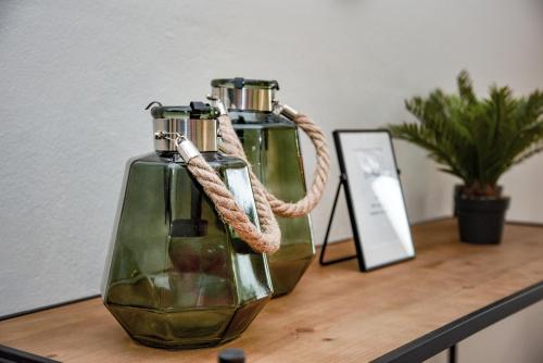two glass bottles on a table with a rope at CasaGreek Monastiraki - Athens in Athens