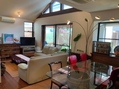 a living room with a couch and a table at Kasumi-an in Kumamoto