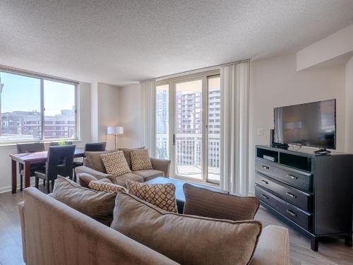 a living room with a couch and a television at National at Ballston Place in Arlington
