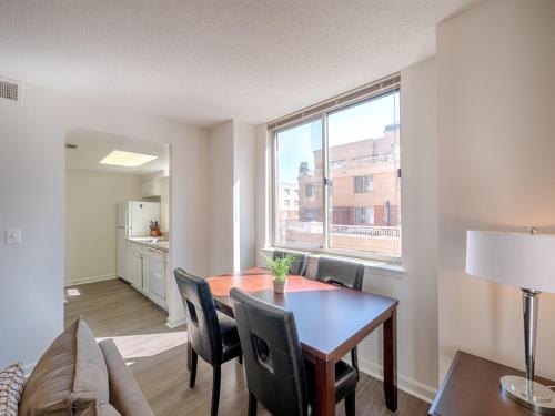 a living room with a dining room table and a window at National at Ballston Place in Arlington