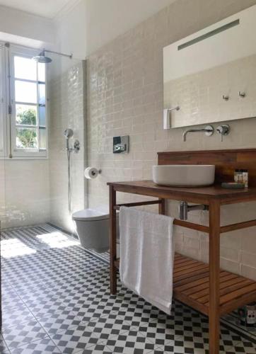 a bathroom with a sink and a tub and a toilet at Casa Oliveira Esmeraldo - Guest Houses in São Vicente