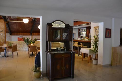 a dining room with a table and a cabinet at Penzión ARTin in Nitra