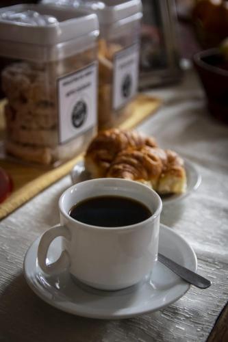 a cup of coffee and a pastry on a table at Hotel Federico I in Concordia