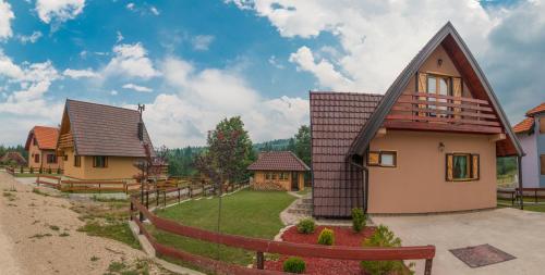 uma casa com uma cerca em frente a um quintal em Mountain house Popović Tara em Bajina Bašta