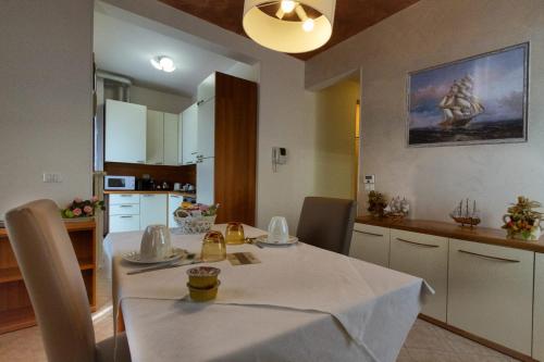 a kitchen with a table with a white table cloth on it at Residence San Miguel (6) in Vicenza