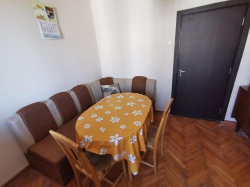 a dining room with a table and chairs and a door at Mountain view apartment in Vratsa