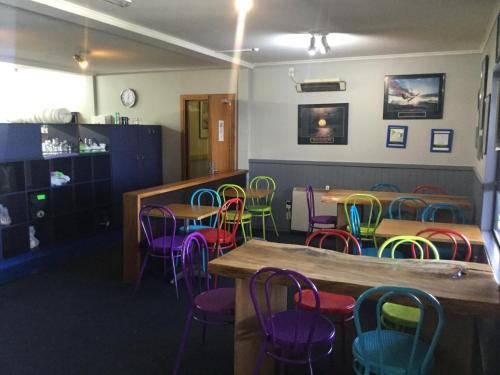 uma sala de jantar com mesas e cadeiras coloridas em Ivorytowers Accommodation em Fox Glacier
