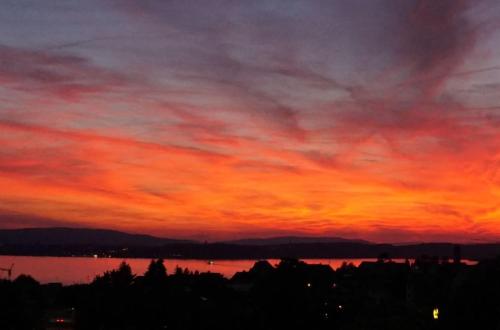 a sunset over a body of water at Haus am Trielberg in Meersburg