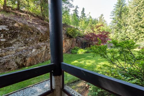 a view from a window of a garden at The Ironwood on Blueberry Hill in Whistler
