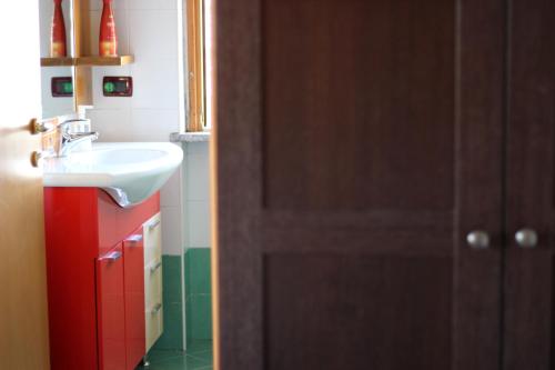 a bathroom with a sink and a mirror and a door at La Casa Zen in San Giovanni Teatino