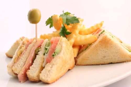 a sandwich and french fries on a white plate at Hotel Ferri in Oaxaca City