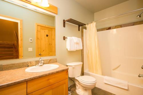 a bathroom with a toilet and a sink at 3 BR 3 Bath ski in ski out with private hot tub in Big White