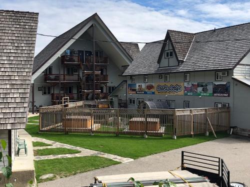 a building with a fence in front of it at Peaks Lodge in Revelstoke