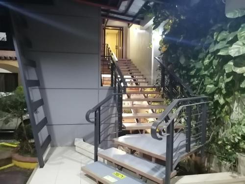 a set of stairs leading up to a building at Manora Apartment in Talisay