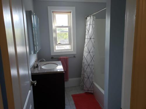 a bathroom with a sink and a window and a shower at shared house in Federal Hill in Providence