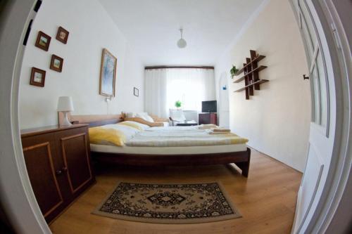 a bedroom with a large bed and a large window at Privat No. 40 in Telč