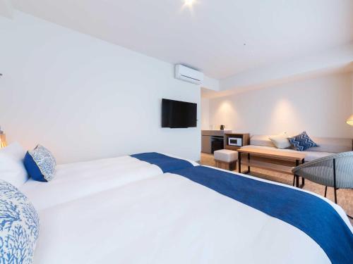 Ένα ή περισσότερα κρεβάτια σε δωμάτιο στο Tokyu Stay Okinawa Naha