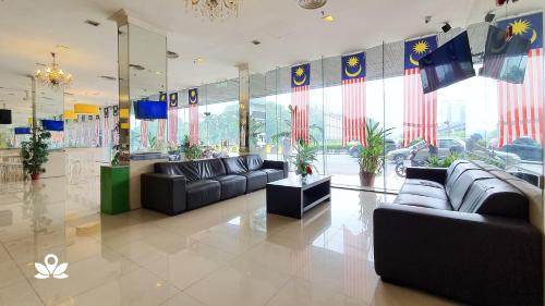 a lobby with couches and flags in a building at SCC Hotel in Kuala Lumpur