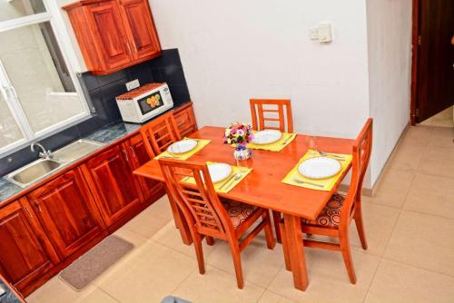 a kitchen with a wooden table with chairs and a sink at Furnished apartment at Colombo suburbs Nawala in Rajagiriya
