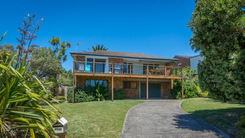 a house with a walkway in front of it at By The Sea, Culburra Beach in Culburra Beach