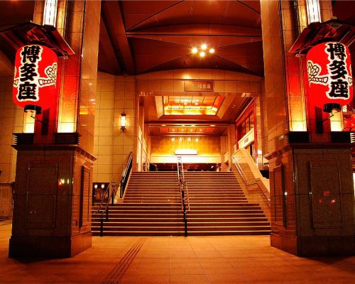 a staircase in a building with red signs on it at THE HOTELS HAKATA KASANE Bayside in Fukuoka