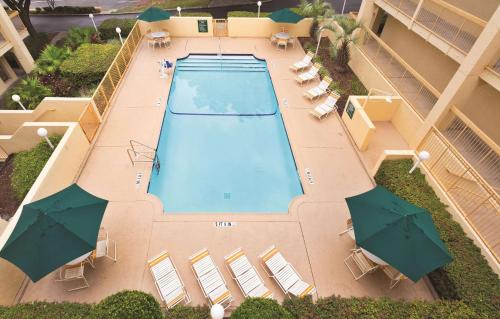 an overhead view of a swimming pool with umbrellas at Days Inn by Wyndham Gainesville Florida in Gainesville