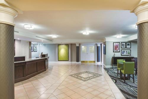 a lobby of a hotel with a reception desk and columns at Days Inn by Wyndham Gainesville Florida in Gainesville