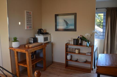 a living room with a microwave and a table with a microwave at Whale Tale in Cape Town