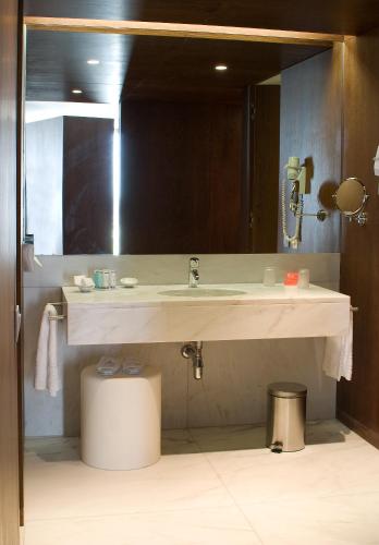 a bathroom with a sink and a large mirror at Pousada Palacio de Estoi – Small Luxury Hotels of the World in Estói