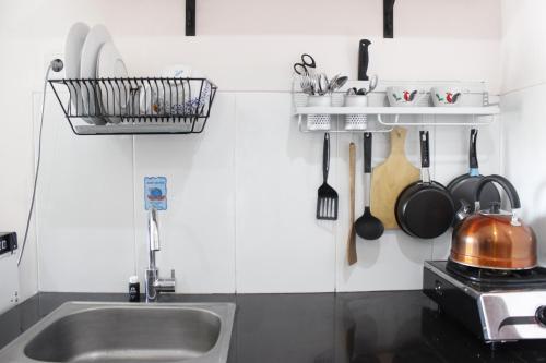 a kitchen with a sink and a counter top at Spacious and Well Appointed 2BR @ Gateway Pasteur Apartment By Travelio in Bandung