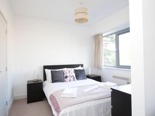 ein weißes Schlafzimmer mit einem großen Bett und einem Fenster in der Unterkunft Modern Oxford Apartment - Sleeps 4 in Oxford