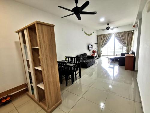 a living room with a ceiling fan and a dining room at Cozy Ipoh Homestay in Ipoh