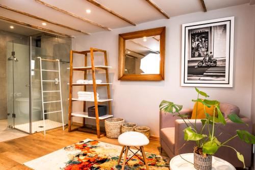 a living room with a couch and a mirror at Pablo House in Johannesburg