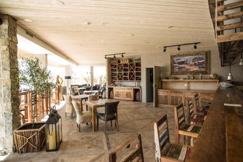 a restaurant with wooden ceilings and tables and chairs at Surfers Lodge Peniche in Peniche