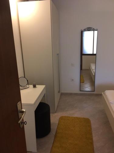 a bathroom with a desk and a mirror and a sink at Vila Mozara in Slano